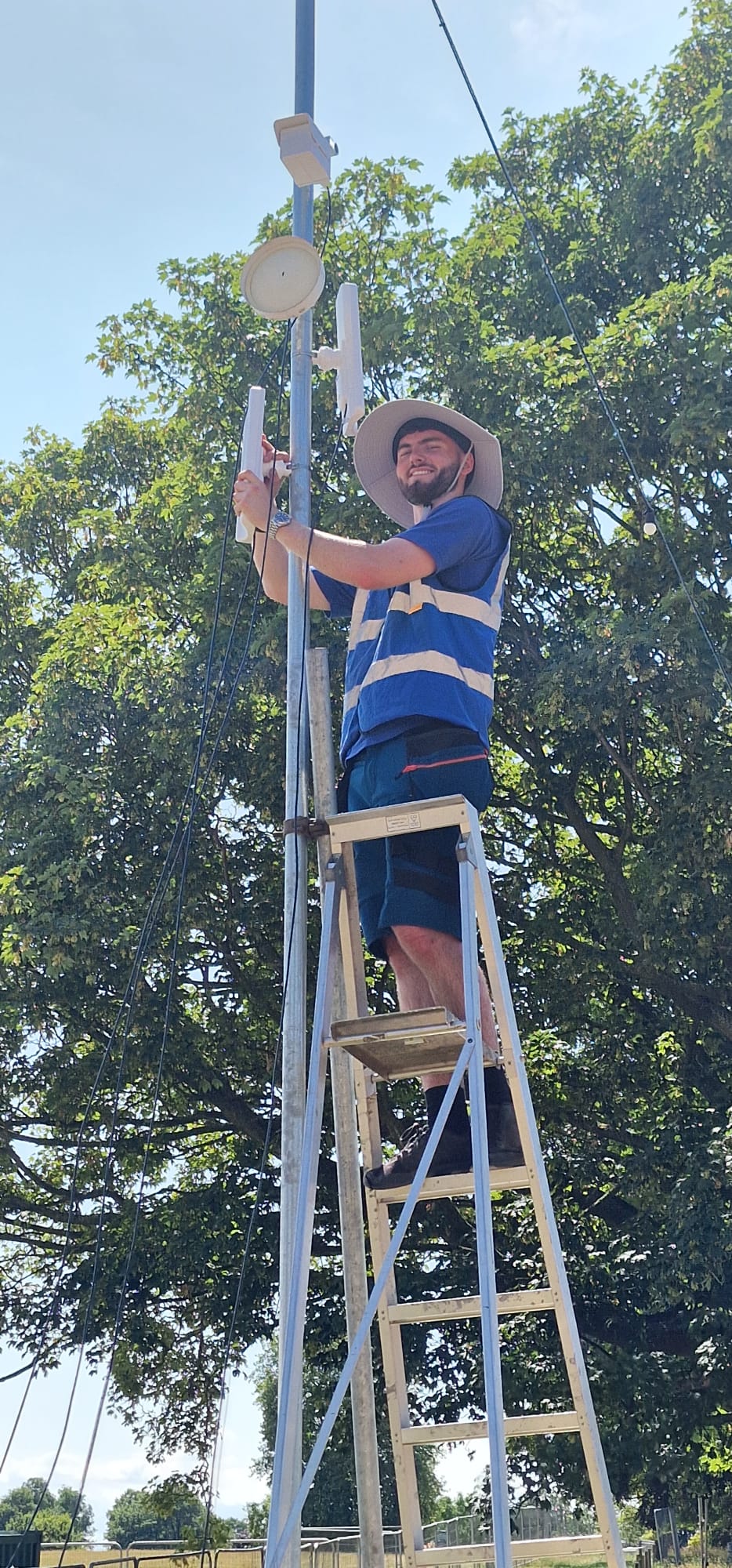 HTG engineer Nathan installing wireless access point and point-to-point links at Deershed Festival 2026